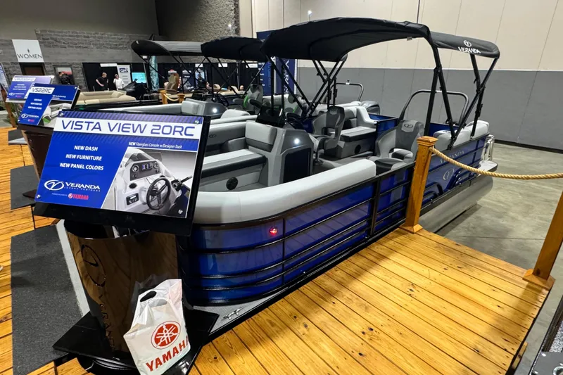 Slide: The Image of 2026 Veranda Vista View 20RC pontoon boat displayed indoors with new features highlighted. - 1