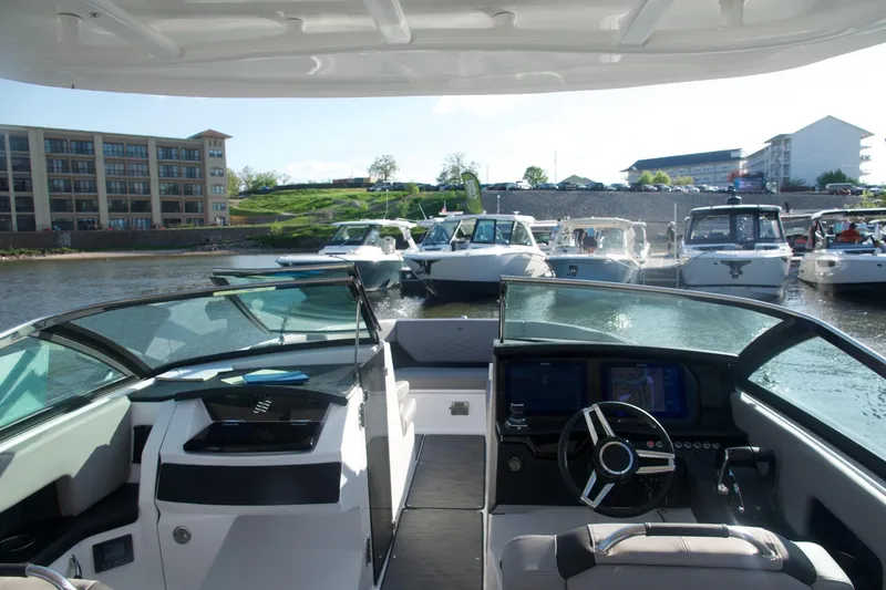 Slide: The Image of Interior of 2025 Four Winns H9 boat with modern dashboard and steering wheel. - 4