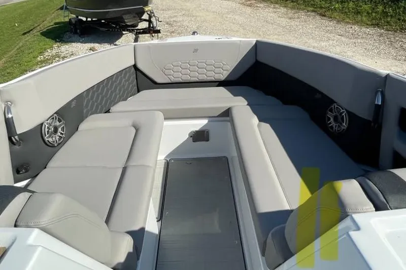 Slide: The Image of Interior view of 2025 Four Winns H9 boat docked at a marina. - 5