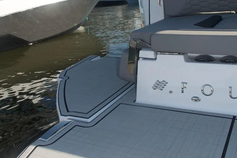 Slide: The Image of 2025 Four Winns H9 boat interior with gray seating and modern design elements. - 7
