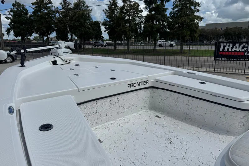 Slide: The Image of Frontier 2104 boat, 2011 model, white deck, outdoor setting, trees in background. - 11