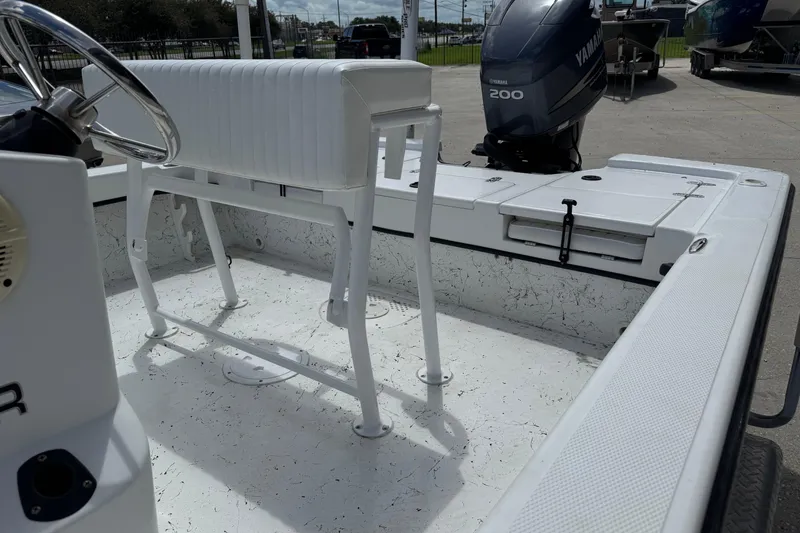 Slide: The Image of Frontier 2104 boat interior with Yamaha 200 engine, featuring white seating and deck. - 13
