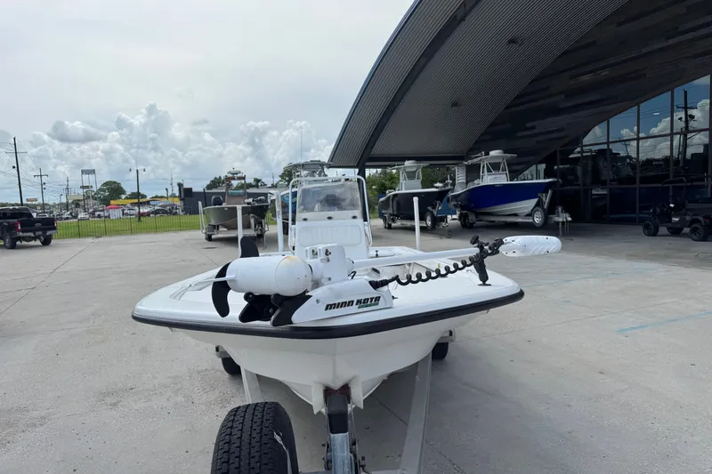 Slide: The Image of 2011 Frontier 2104 boat with Minn Kota motor, parked outside a dealership. - 4