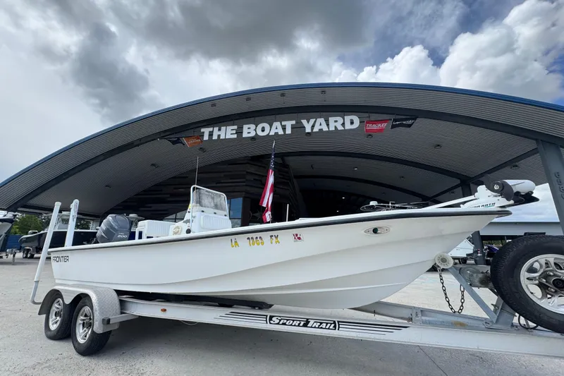 Slide: The Image of 2011 Frontier 2104 boat on trailer at The Boat Yard under cloudy sky. - 6