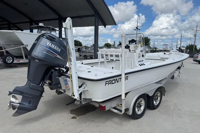Slide: The Image of 2011 Frontier 2104 boat with Yamaha motor on trailer, parked outdoors. - 7