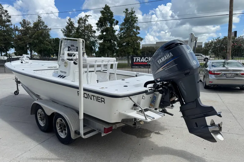 Slide: The Image of 2011 Frontier 2104 boat with Yamaha motor on trailer, parked outdoors. - 8