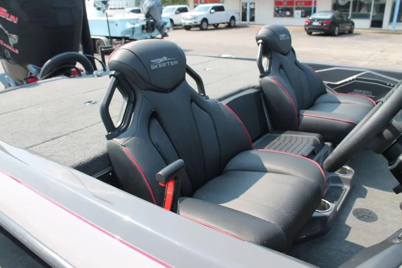 Slide: The Image of 2025 Skeeter ZXR21 boat interior with sleek black seats and red accents. - 8