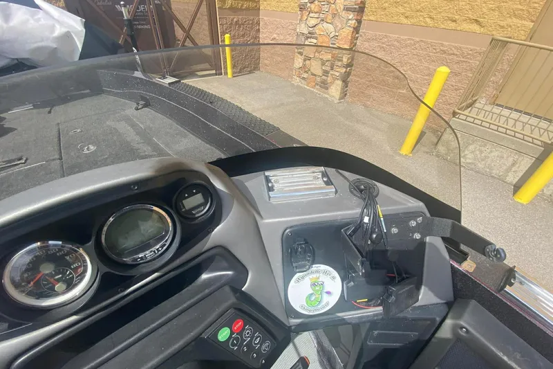 Slide: The Image of 2017 Ranger 621FS Fisherman boat dashboard with gauges and controls in a parking area. - 19