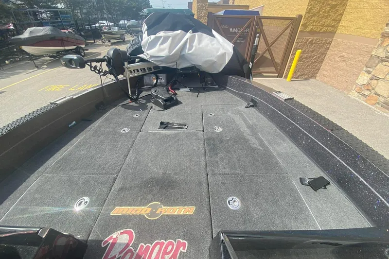Slide: The Image of 2017 Ranger 621FS Fisherman boat deck with Minn Kota trolling motor, parked outdoors. - 21