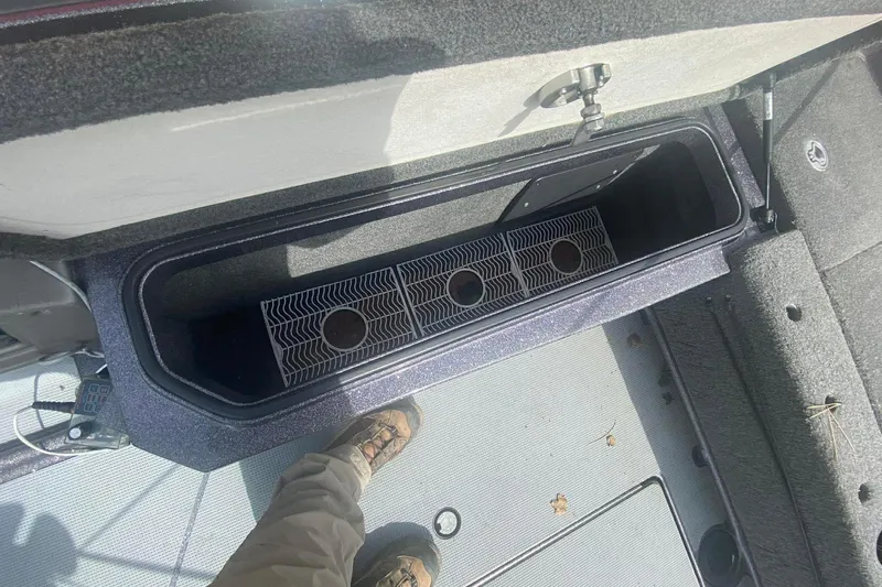 Slide: The Image of 2017 Ranger 621FS Fisherman boat storage compartment with open lid and interior view. - 23