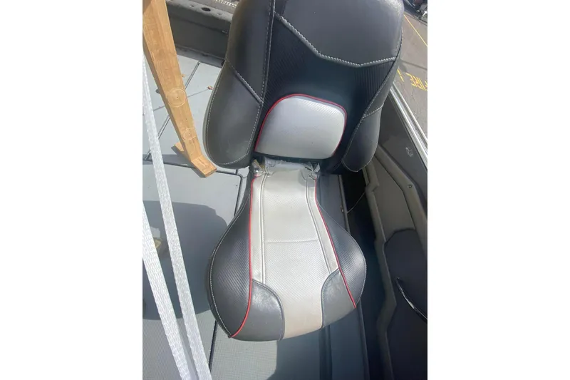 Slide: The Image of 2017 Ranger 621FS Fisherman boat seat, black and gray with red accents, in a fishing vessel. - 26