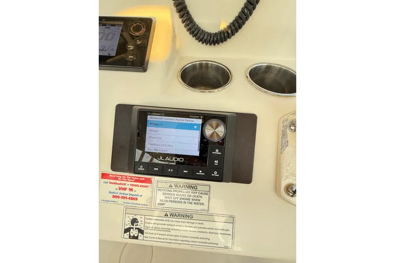 Slide: The Image of Control panel of a 2016 Cobia 296 Center Console boat with Bluetooth connectivity. - 37