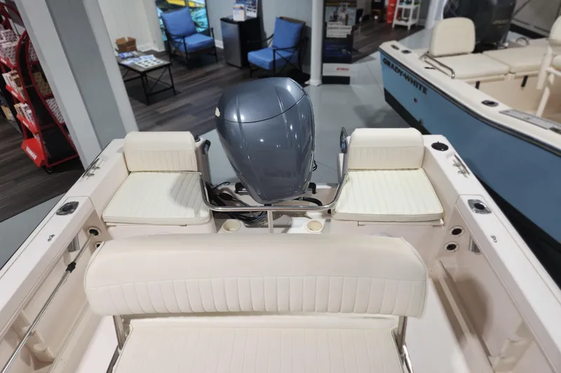 Slide: The Image of 1999 Grady-White Sportsman 180 boat interior with seating and motor in showroom. - 11