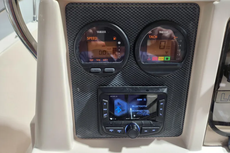 Slide: The Image of Dashboard of 1999 Grady-White Sportsman 180 with Yamaha gauges and Bluetooth stereo. - 12