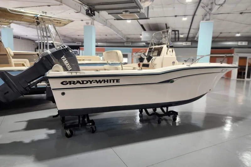 Slide: The Image of 1999 Grady-White Sportsman 180 boat with Yamaha engine in showroom setting. - 2