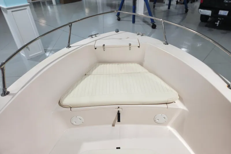 Slide: The Image of 1999 Grady-White Sportsman 180 boat interior with cushioned seating and stainless steel railings. - 5
