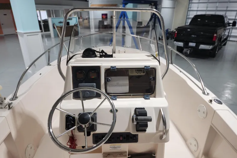 Slide: The Image of 1999 Grady-White Sportsman 180 boat dashboard with steering wheel and controls. - 9