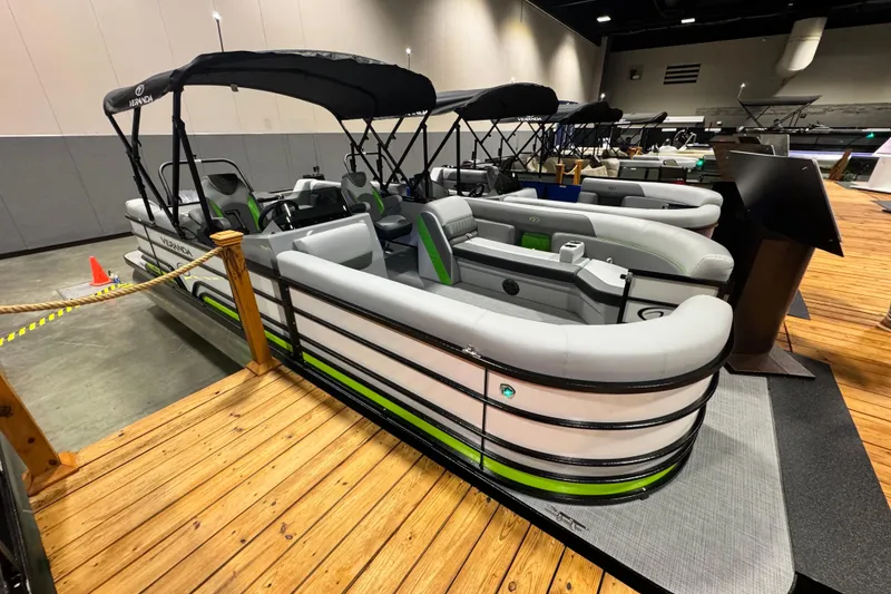 Slide: The Image of 2026 Veranda Vista View Sport VS22RC pontoon boat displayed indoors on wooden platform. - 1