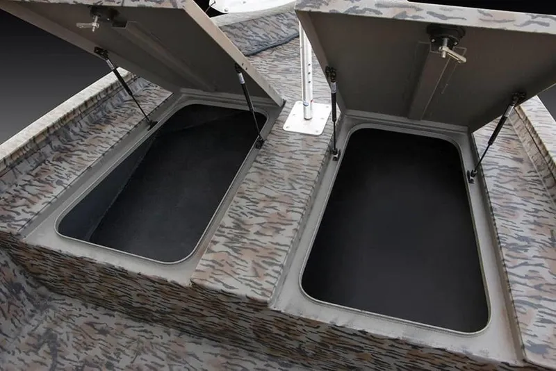 Slide: The Image of Open storage compartments on 2026 Xpress H190B boat with camo pattern. - 10