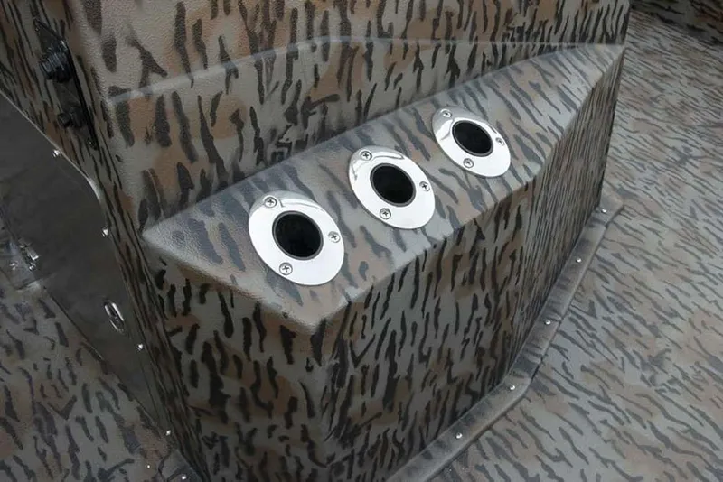 Slide: The Image of Camouflage-patterned Xpress H190B boat interior with three rod holders, 2026 model. - 3