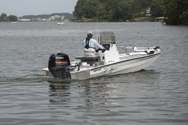 Slide: The Image of 2026 Xpress H190B boat with Yamaha engine on a calm lake. - 8