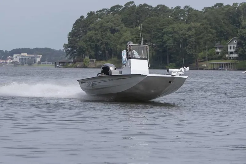 Slide: The Image of 2026 Xpress H190B boat cruising on a scenic lake with lush greenery. - 9