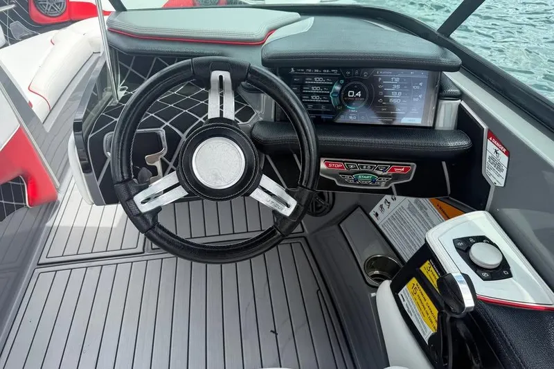 Slide: The Image of 2018 Nautique Super Air Nautique GS22 dashboard with steering wheel and digital display. - 10