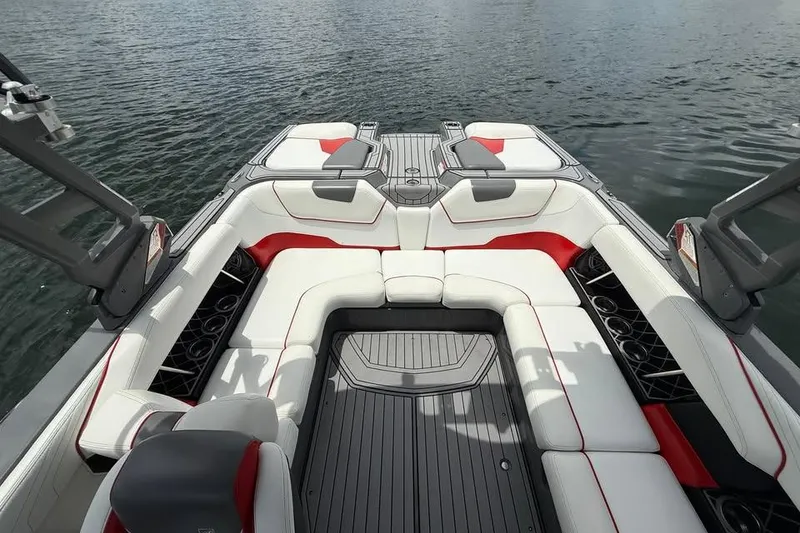 Slide: The Image of 2018 Nautique Super Air Nautique GS22 interior with white and red seating on water. - 9