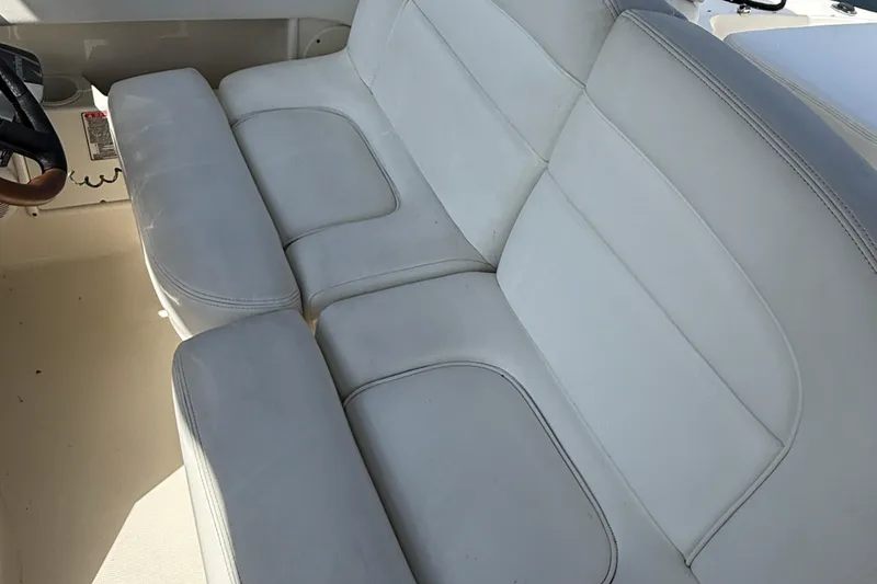 Slide: The Image of White leather seating on 2005 Sea Ray 300 Sundancer boat interior. - 11