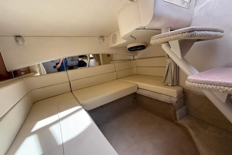 Slide: The Image of Interior of 2005 Sea Ray 300 Sundancer with beige seating and carpeted steps. - 16