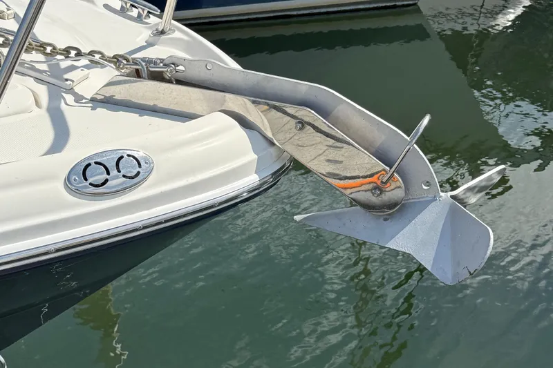 Slide: The Image of Anchor on 2005 Sea Ray 300 Sundancer boat, docked in calm water. - 2
