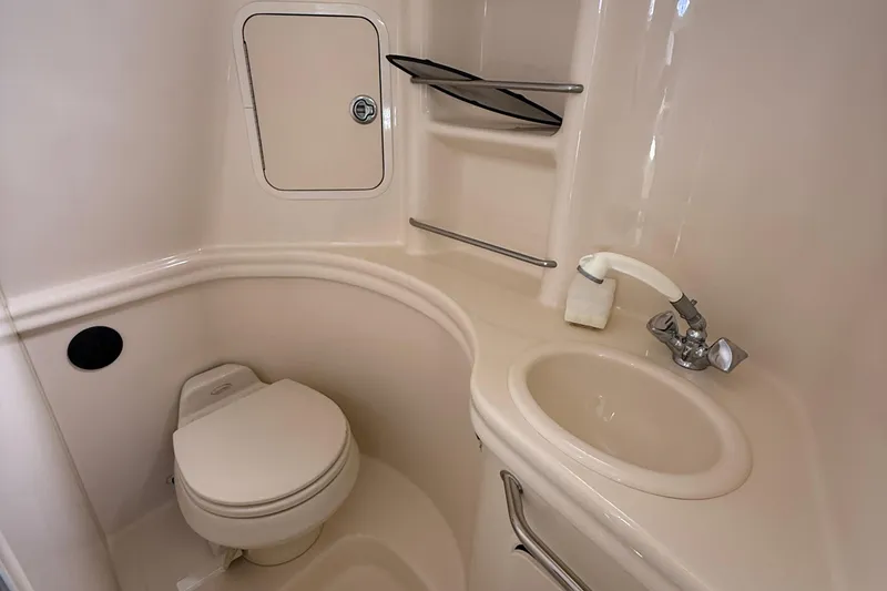 Slide: The Image of Compact bathroom in 2005 Sea Ray 300 Sundancer boat with toilet and sink. - 24