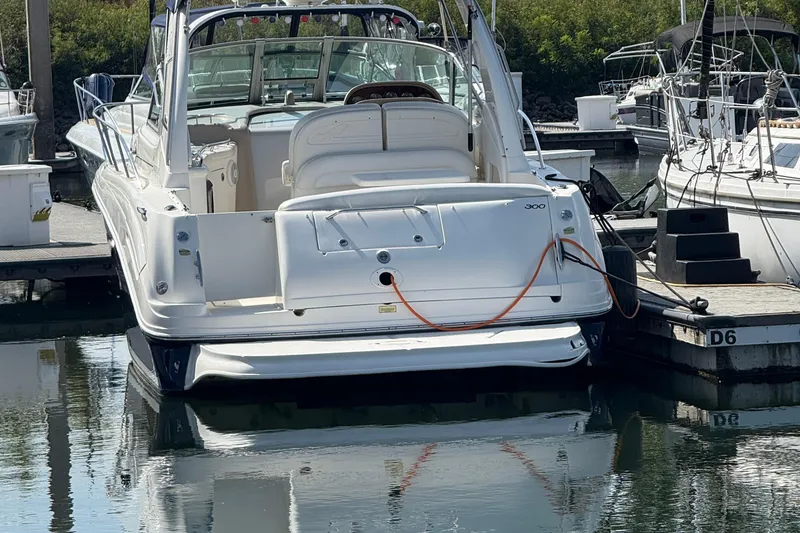 Slide: The Image of 2005 Sea Ray 300 Sundancer docked at marina, rear view. - 3