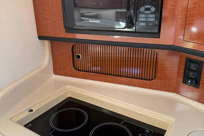 Slide: The Image of 2005 Sea Ray 300 Sundancer kitchen with stove and microwave. - 35