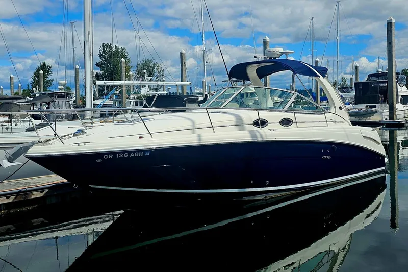 Slide: The Image of 2005 Sea Ray 300 Sundancer boat docked at marina under blue sky. - 42