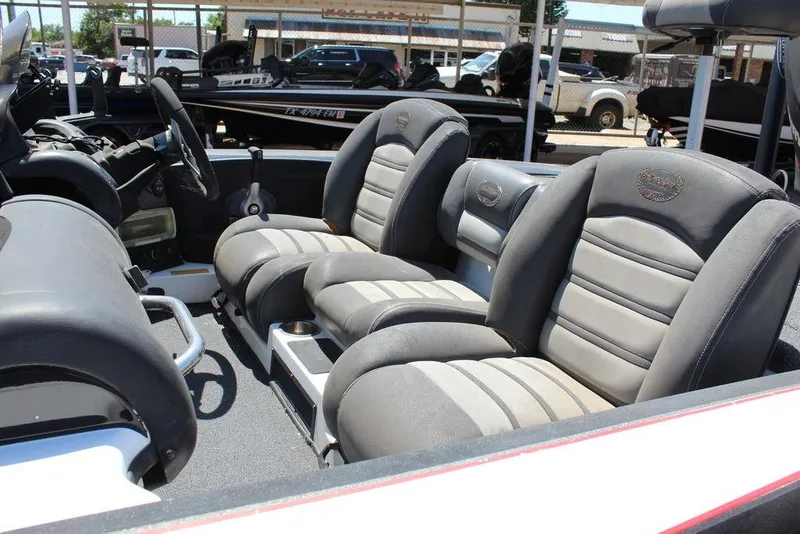 Slide: The Image of 2008 Triton Tr21 X boat interior with gray cushioned seats and steering wheel. - 11