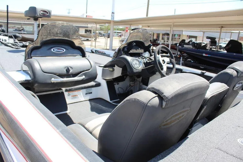 Slide: The Image of 2008 Triton Tr21 X boat interior with steering wheel and seating. - 13