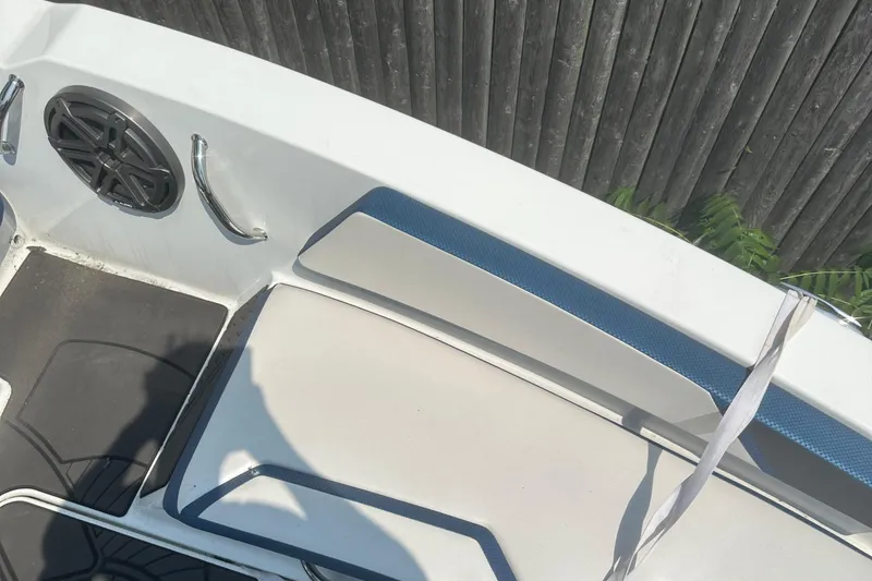 Slide: The Image of 2021 Scarab 165 ID boat with registration NY 8151 MS, parked on gravel. - 2