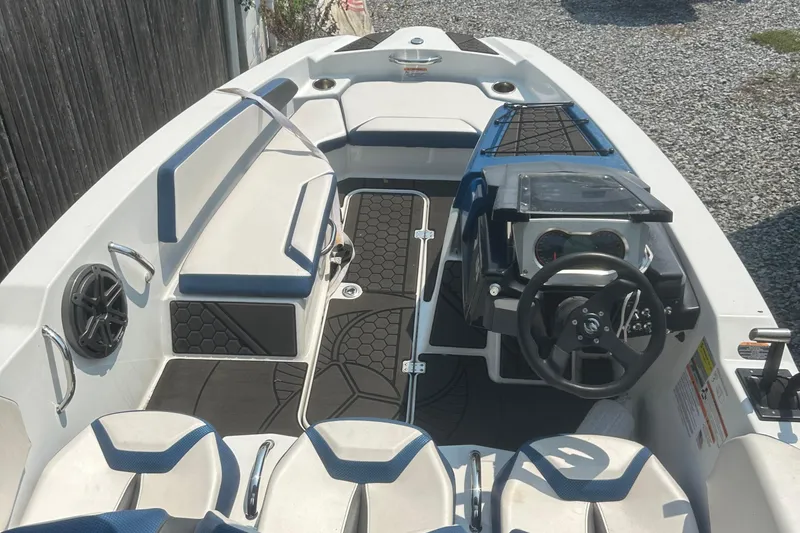 Slide: The Image of Rear view of a 2021 Scarab 165 ID boat with Rotax engine, parked outdoors. - 5