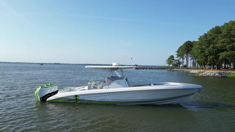 Slide: The Image of 2023 Statement 350 Open boat on calm water near a wooded shoreline. - 4