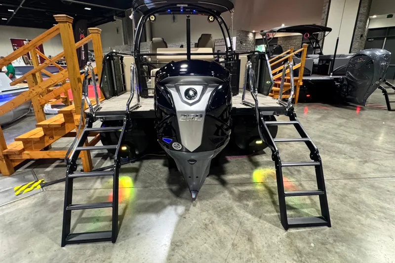 Slide: The Image of 2026 Veranda Relax VR265VLI pontoon boat with dual ladders on display indoors. - 19