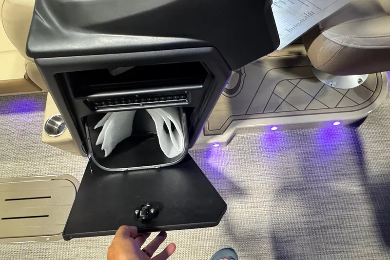 Slide: The Image of Open storage compartment in 2026 Veranda Relax VR265VLI boat, featuring ambient blue lighting. - 9