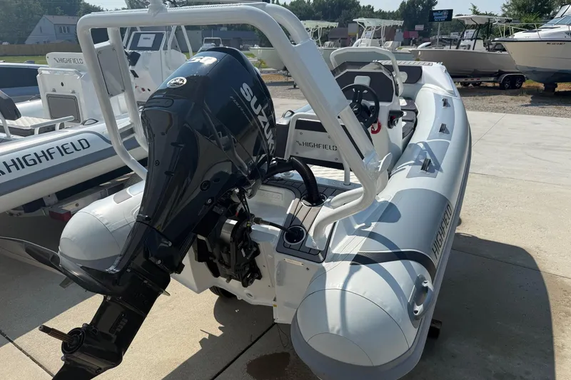 Slide: The Image of 2025 Highfield Sport 390 boat with Suzuki outboard motor, displayed outdoors. - 11