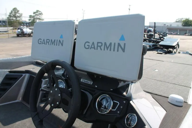 Slide: The Image of 2025 Skeeter ZXR21 boat dashboard with dual Garmin displays and steering wheel. - 10