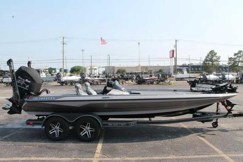 Slide: The Image of 2025 Skeeter ZXR21 boat on trailer in parking lot, side view. - 3