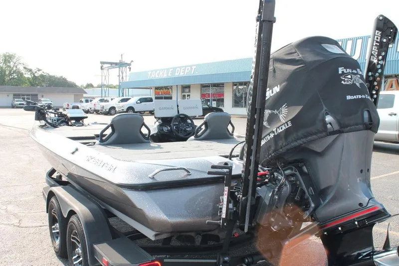 Slide: The Image of 2025 Skeeter ZXR21 boat with advanced Garmin electronics, parked outside a tackle shop. - 5