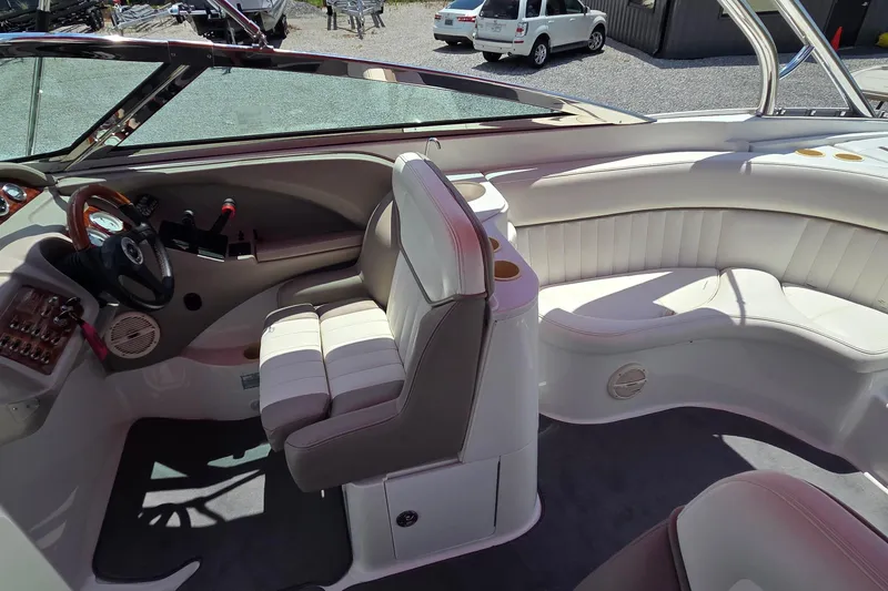Slide: The Image of Interior of a 2003 Cobalt 282 boat with white seating and control panel. - 10
