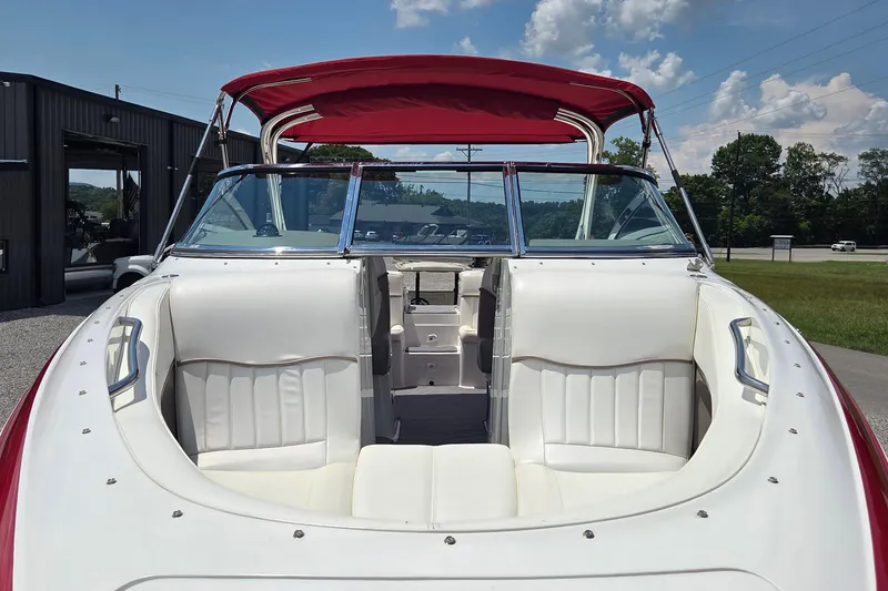 Slide: The Image of 2003 Cobalt 282 boat with red canopy, white seating, and open deck view. - 12