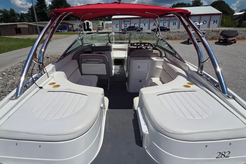 Slide: The Image of 2003 Cobalt 282 boat interior with red canopy and white seating. - 4
