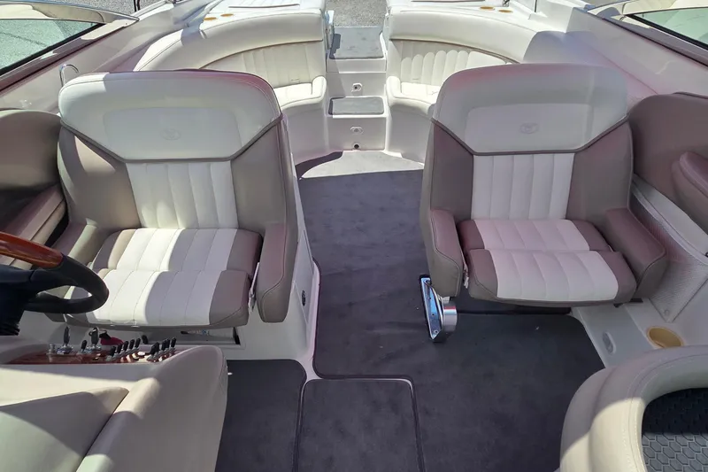 Slide: The Image of Interior of a 2003 Cobalt 282 boat with plush seating and steering controls. - 7